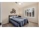 Bright bedroom with carpet, a blue striped quilt and modern decor at 16055 S 18Th Dr, Phoenix, AZ 85045