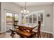 Dining area with a wooden table, bench seating, and sliding glass doors to the backyard, ideal for Gathering meals at 16055 S 18Th Dr, Phoenix, AZ 85045
