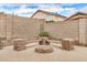 Brick fire pit with built-in seating, perfect for outdoor entertaining at 16055 S 18Th Dr, Phoenix, AZ 85045