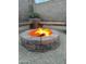 Outdoor fire pit with stone surround and wooden benches, ideal for cool evenings at 16055 S 18Th Dr, Phoenix, AZ 85045