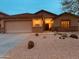 Inviting home exterior with a desert landscaped front yard and a well-lit entrance at 16055 S 18Th Dr, Phoenix, AZ 85045