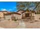 Well-maintained front yard with desert landscaping and charming walkway at 16055 S 18Th Dr, Phoenix, AZ 85045