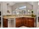 Kitchen area showcasing granite countertops, stainless steel sink, and wooden cabinetry at 16055 S 18Th Dr, Phoenix, AZ 85045