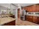 Bright kitchen features stainless steel appliances, granite countertops, wood cabinetry, and views to breakfast nook at 16055 S 18Th Dr, Phoenix, AZ 85045