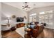 Inviting living room with vaulted ceilings, comfortable leather seating, and natural light, perfect for relaxation at 16055 S 18Th Dr, Phoenix, AZ 85045