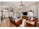 Bright living room with vaulted ceilings, hardwood floors, and comfortable leather seating, creating an inviting space at 16055 S 18Th Dr, Phoenix, AZ 85045