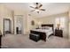 Spacious main bedroom with a ceiling fan, ensuite bathroom, and ample natural light at 16055 S 18Th Dr, Phoenix, AZ 85045