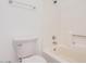 Clean bathroom featuring a white toilet, tub, and tiled walls at 16602 N 25Th St # 223, Phoenix, AZ 85032