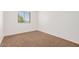 Bright bedroom featuring a window, neutral paint, and plush carpet at 16602 N 25Th St # 223, Phoenix, AZ 85032