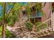 Charming multi-level exterior with staircases leading to units and lush landscaping, perfect for a serene living environment at 16602 N 25Th St # 223, Phoenix, AZ 85032