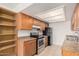 Functional kitchen featuring wooden cabinets, tile floors, and essential appliances for a convenient cooking experience at 16602 N 25Th St # 223, Phoenix, AZ 85032