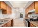 Clean kitchen with wood cabinets, tiled floor, and modern appliances at 16602 N 25Th St # 223, Phoenix, AZ 85032
