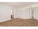 Spacious living room with neutral paint, plush carpet, and bright, natural light at 16602 N 25Th St # 223, Phoenix, AZ 85032