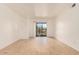 Spacious living room with light hardwood floors and sliding glass doors, offering access to outdoor views and natural light at 16602 N 25Th St # 223, Phoenix, AZ 85032