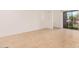 Inviting living room featuring hardwood floors and sliding glass doors that offer a view of the greenery outdoors at 16602 N 25Th St # 223, Phoenix, AZ 85032