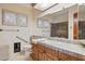 Bathroom with a tiled countertop and two small windows for natural lighting at 17030 N 57Th St, Scottsdale, AZ 85254
