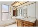 Bright bathroom with a large mirror, wooden vanity, and natural light at 17030 N 57Th St, Scottsdale, AZ 85254