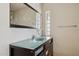 A modern vanity with a glass countertop and sleek fixtures complements the clean lines of the bathroom at 17030 N 57Th St, Scottsdale, AZ 85254