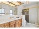 Well-lit bathroom with a shower and a wooden vanity at 17030 N 57Th St, Scottsdale, AZ 85254