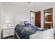 Bedroom with a white bed frame and an ensuite bathroom entrance at 17030 N 57Th St, Scottsdale, AZ 85254
