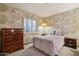 Cozy bedroom featuring floral wallpaper, carpet, and a window with sheer curtains at 17030 N 57Th St, Scottsdale, AZ 85254