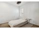 Bedroom features a neutral color scheme, large window with plantation shutters, and a small bedside table at 17030 N 57Th St, Scottsdale, AZ 85254