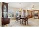 Elegant dining room features chandelier lighting, neutral paint, wooden floors and furniture, and large windows at 17030 N 57Th St, Scottsdale, AZ 85254