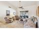 Spacious living room boasting tile floors, comfortable seating, and a large window overlooking the patio at 17030 N 57Th St, Scottsdale, AZ 85254