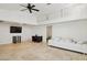 Bright living room with tile flooring, tall ceilings, and a modern white couch at 17030 N 57Th St, Scottsdale, AZ 85254