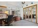 Bright home office featuring a large desk, ample lighting, and mirrored closet doors at 17030 N 57Th St, Scottsdale, AZ 85254