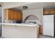 Outdoor kitchen equipped with cabinets, countertop space, a refrigerator, and cooking area at 17030 N 57Th St, Scottsdale, AZ 85254