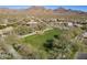 Aerial shot showcasing a spacious green field in a community, bordered by mature trees and elegant landscaping at 17303 N 98Th Pl, Scottsdale, AZ 85255