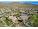 Community aerial view showcasing pools and manicured landscaping between luxury homes with mountain views in the background at 17303 N 98Th Pl, Scottsdale, AZ 85255