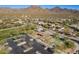 Community aerial view of a playground, basketball court, parking lot, and houses set against a mountain backdrop at 17303 N 98Th Pl, Scottsdale, AZ 85255