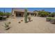 Backyard with desert landscaping, including mature cacti, bushes and rock groundcover at 17303 N 98Th Pl, Scottsdale, AZ 85255