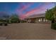 Evening backyard view with desert landscaping and a covered patio; sunset at 17303 N 98Th Pl, Scottsdale, AZ 85255