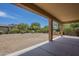Covered patio overlooks a large backyard with desert landscaping at 17303 N 98Th Pl, Scottsdale, AZ 85255