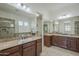 Bathroom with double sink vanity, granite countertops, walk in shower, and large mirror at 17303 N 98Th Pl, Scottsdale, AZ 85255