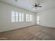 Carpeted bedroom with ceiling fan, plantation shutters, and access to the backyard at 17303 N 98Th Pl, Scottsdale, AZ 85255