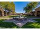Beautiful courtyard featuring a central fountain, well-manicured landscaping, and mature trees at 17303 N 98Th Pl, Scottsdale, AZ 85255