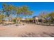 Wide, pavered circular driveway with desert landscaping showcasing the property's unique architectural details at 17303 N 98Th Pl, Scottsdale, AZ 85255