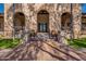 Inviting entrance with stone accents, colorful tiled steps, and decorative flower pots at 17303 N 98Th Pl, Scottsdale, AZ 85255