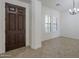 Entry way with tile flooring, dark wood door and window with white shutters at 17303 N 98Th Pl, Scottsdale, AZ 85255