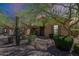 Tan home with a desert xeriscape front yard featuring various bushes, cactus and trees at 17303 N 98Th Pl, Scottsdale, AZ 85255