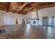 Spacious room boasts vaulted wood-beam ceilings and a fireplace for a warm, inviting atmosphere at 17303 N 98Th Pl, Scottsdale, AZ 85255