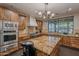 Gourmet kitchen featuring custom wood cabinets, large center island, and stainless steel appliances at 17303 N 98Th Pl, Scottsdale, AZ 85255
