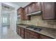 Stylish kitchen featuring granite countertops, tile backsplash, and modern appliances at 17303 N 98Th Pl, Scottsdale, AZ 85255