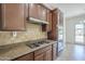 Well-appointed kitchen with granite countertops, gas cooktop, and stainless steel appliances at 17303 N 98Th Pl, Scottsdale, AZ 85255