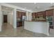 Modern kitchen with dark wood cabinets, stainless steel appliances, and a tiled backsplash at 17303 N 98Th Pl, Scottsdale, AZ 85255