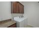 Convenient laundry room with granite countertop, storage cabinets, and a modern washer and dryer at 17303 N 98Th Pl, Scottsdale, AZ 85255